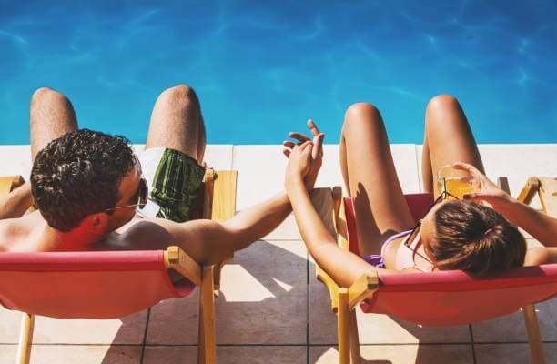 A stress-free couple enjoying their destination wedding, knowing their guest logistics are fully managed by a travel concierge.