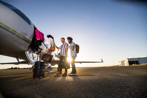 A group of stylish friends boarding a private jet at sunset for an elevated bachelor or bachelorette getaway.