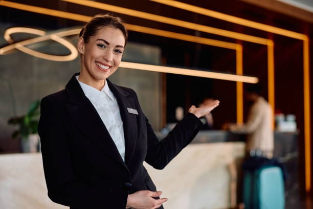 A professional, white-glove hotel concierge assisting a guest at a luxury resort, representing seamless travel management.A professional, white-glove hotel concierge assisting a guest at a luxury resort, representing seamless travel management.