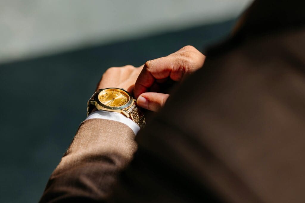 A close-up of an elegant watch on a person's wrist, symbolizing time as the ultimate luxury asset for successful professionals.
