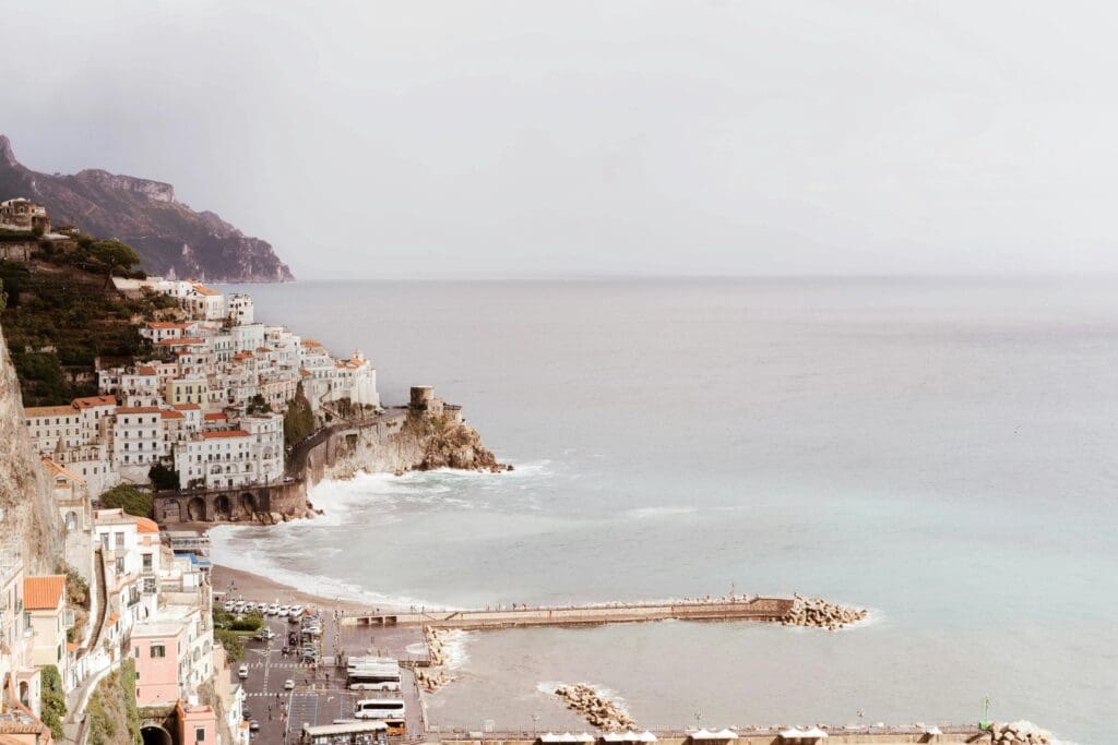 A panoramic view of a picturesque town nestled into the dramatic cliffs of the Amalfi Coast, Italy, a stunning location for a European destination wedding.